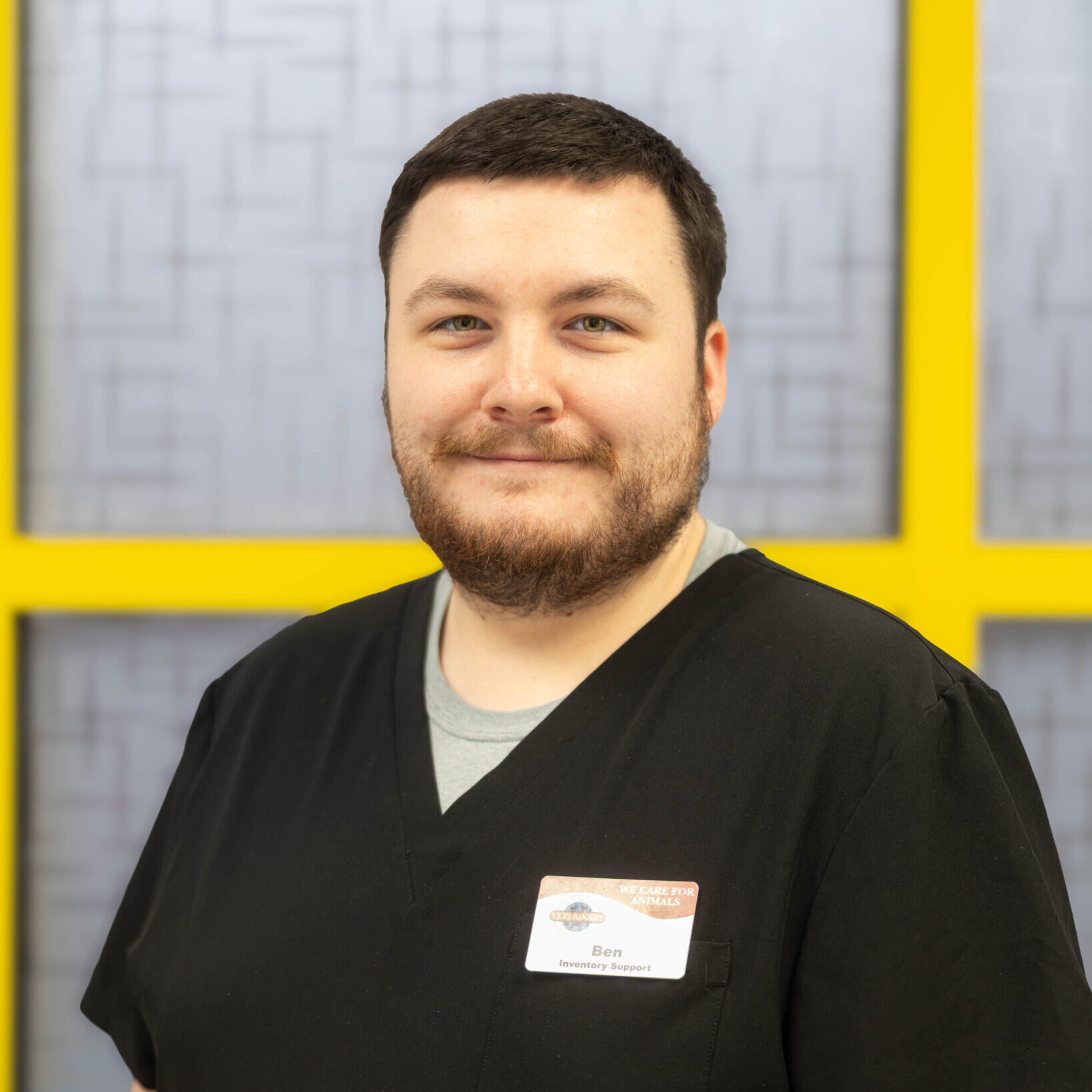 Ben Inventory Assistant Man smiling in black scrubs