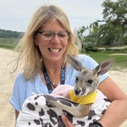 woman holding baby kangaroo